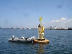 Girl meets buoy - waiting her turn for a sail..