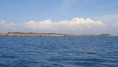 Landscape of the Tour des Ports - part of the iles de Chausey with afternoon cumulus building over the mainland