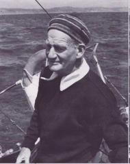 Hugh sailing 'White Nothe' in the bay wearing his characteristic woolly hat