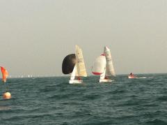 Close action on the downwind leg carefully watched by Adam