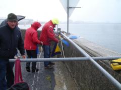 YCC president Jean Le Carpentier helps to rig the flags for racing in the rain!